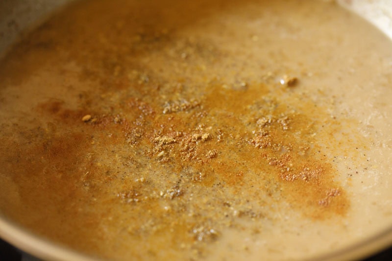 Ground spices sprinkled on ada pradhaman.