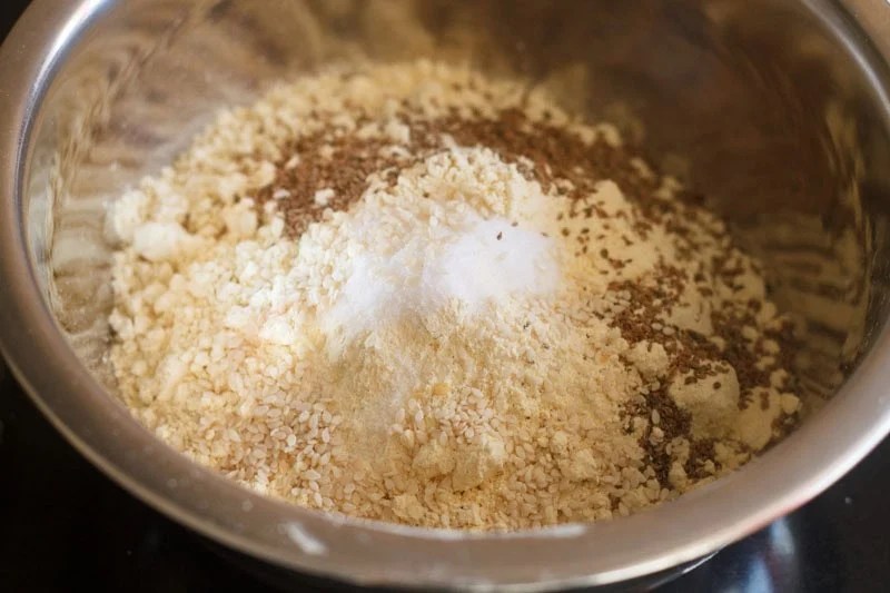Gram flour, carom seeds and salt in a mixing bowl.