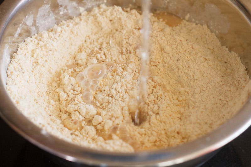 Water being poured on the dry ingredients.