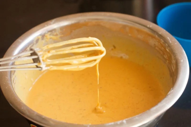 Batter whisked an dripping from the whisk.