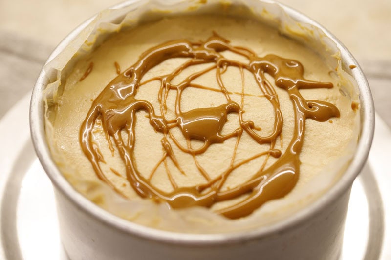 Melted biscoff spread drizzled on refrigerated cheesecake.