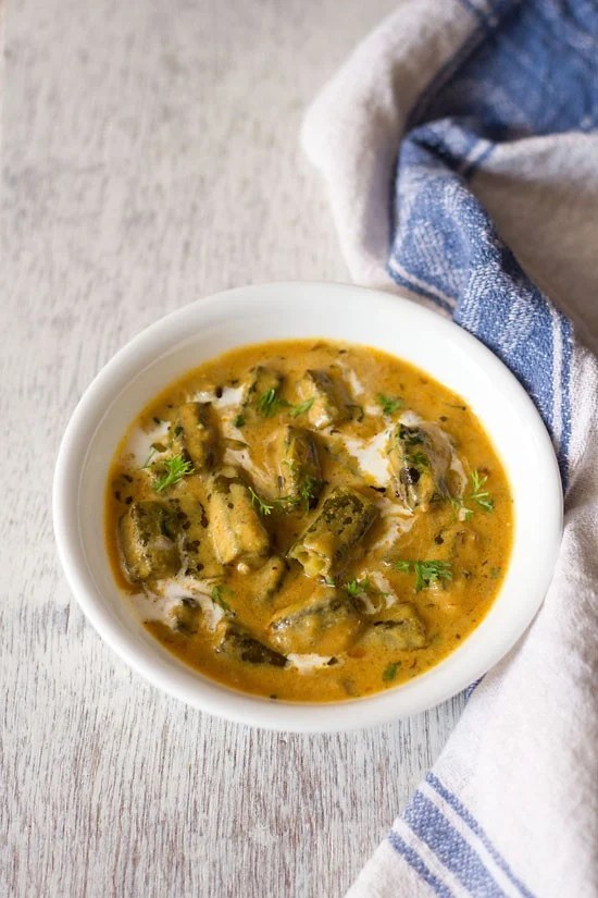 dahi bhindi served in a white bowl.