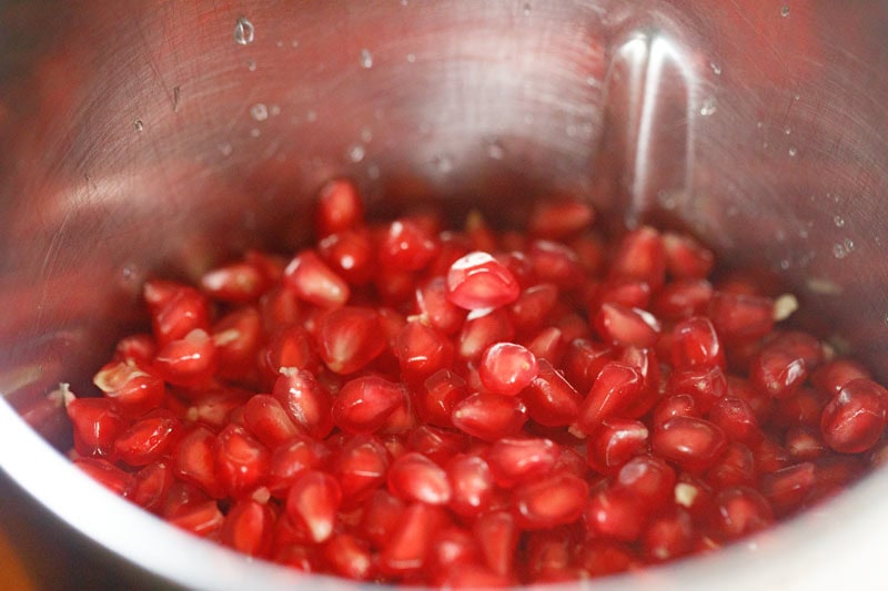 Red pomegranate arils in a blender.