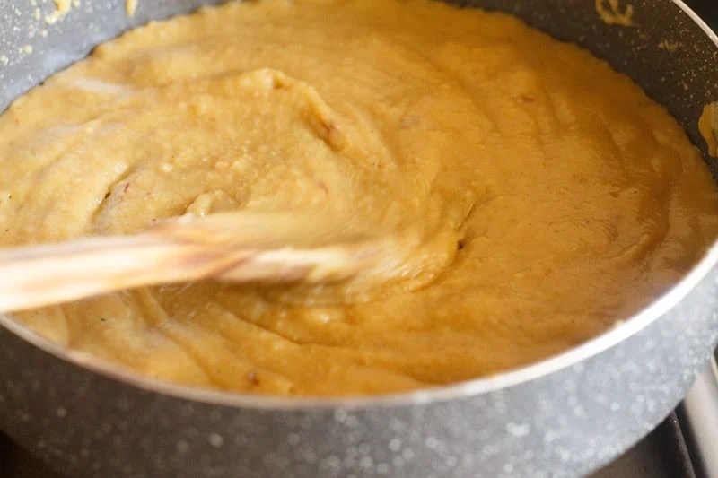 Thickened mawa peda mixture in pan.