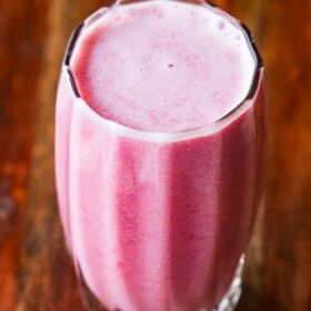 Pomegranate juice in a glass with text layovers.