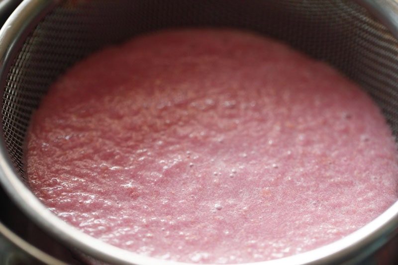 Straining pomegranate juice.